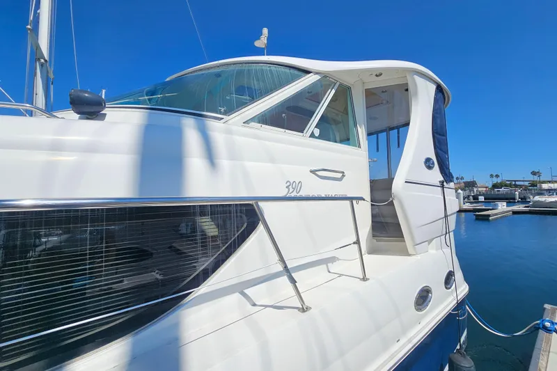 Slide: The Image of 2005 Sea Ray 390 Motor Yacht docked in a marina under clear blue skies. - 5