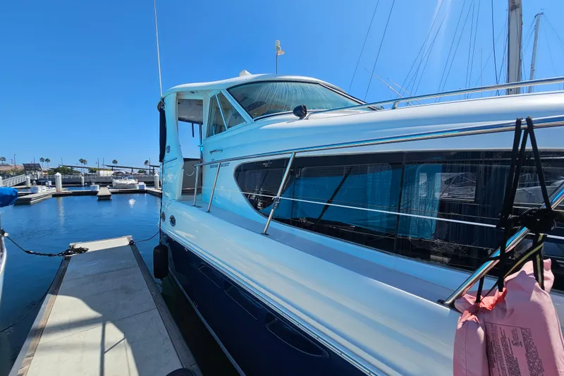 Slide: The Image of 2005 Sea Ray 390 Motor Yacht docked at marina under clear blue sky. - 6