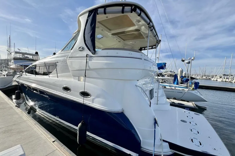 Slide: The Image of 2005 Sea Ray 390 Motor Yacht docked at marina under clear blue sky. - 7