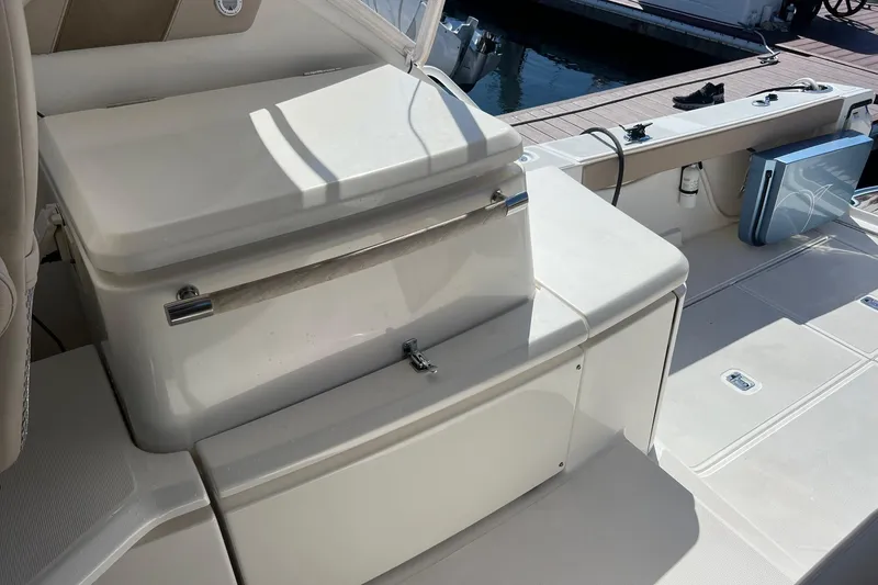 Slide: The Image of 2014 Tiara Yachts 3900 Coronet deck with seating and storage area. - 16