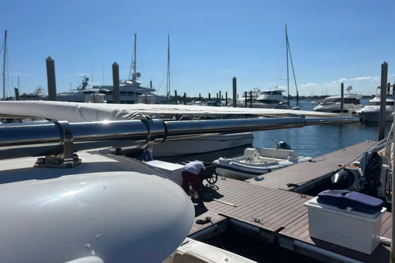 Slide: The Image of 2014 Tiara Yachts 3900 Coronet docked at marina with other boats. - 18