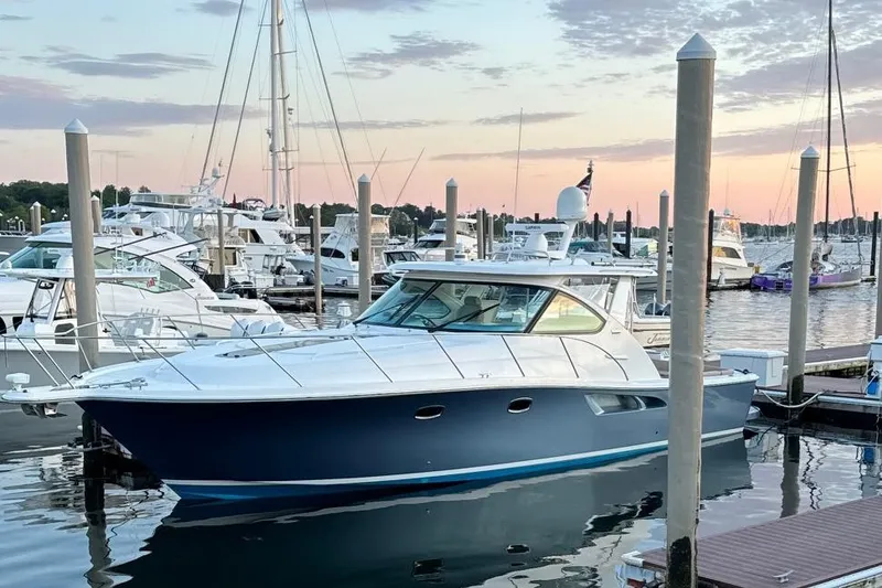 Slide: The Image of 2014 Tiara Yachts 3900 Coronet docked at marina during sunset. - 2