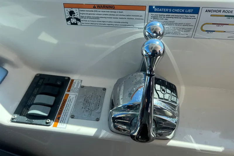 Slide: The Image of Control panel of a 2014 Tiara Yachts 3900 Coronet with throttle and warning labels. - 21