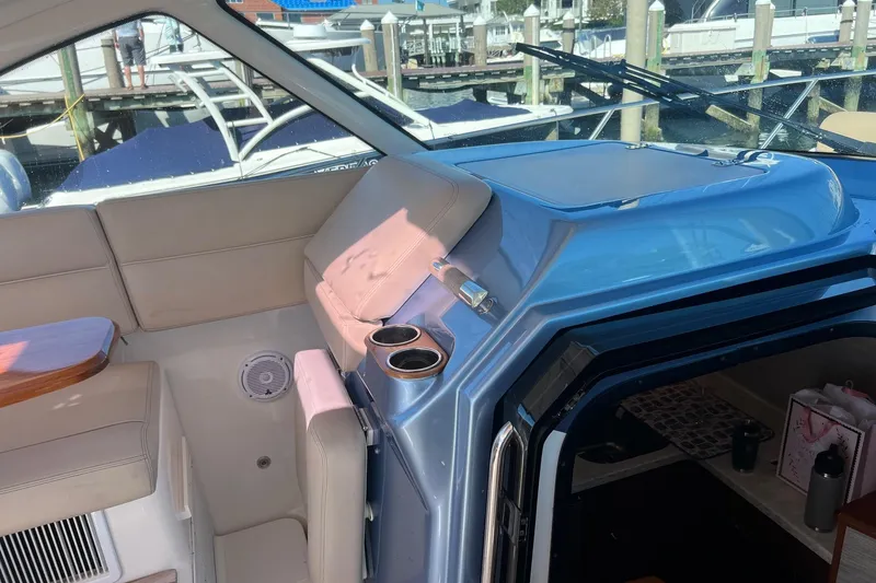 Slide: The Image of 2014 Tiara Yachts 3900 Coronet interior with beige seating and blue accents. - 26