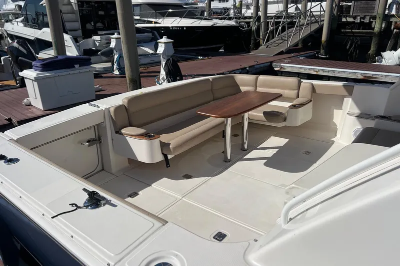 Slide: The Image of 2014 Tiara Yachts 3900 Coronet with spacious seating and table at the dock. - 33
