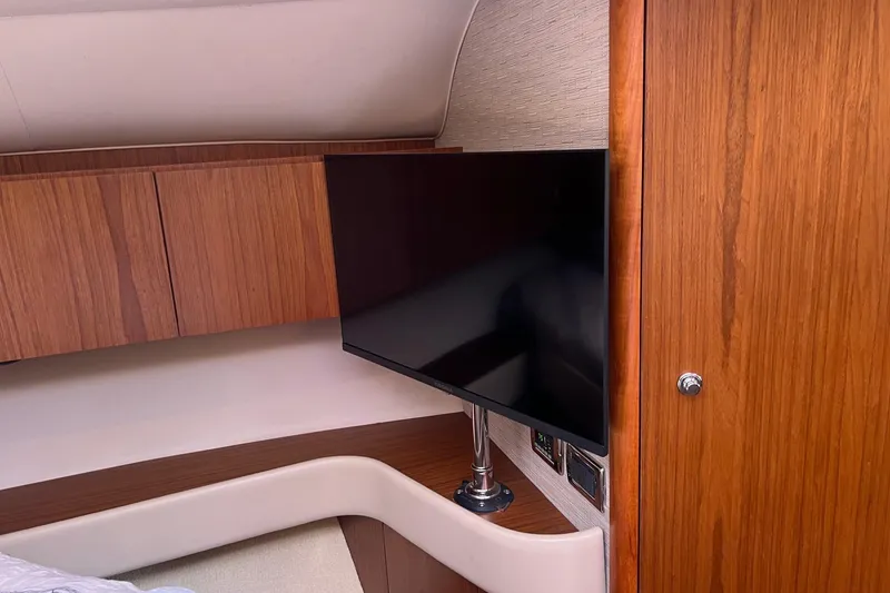 Slide: The Image of Interior of 2014 Tiara Yachts 3900 Coronet with TV and wooden cabinetry. - 35