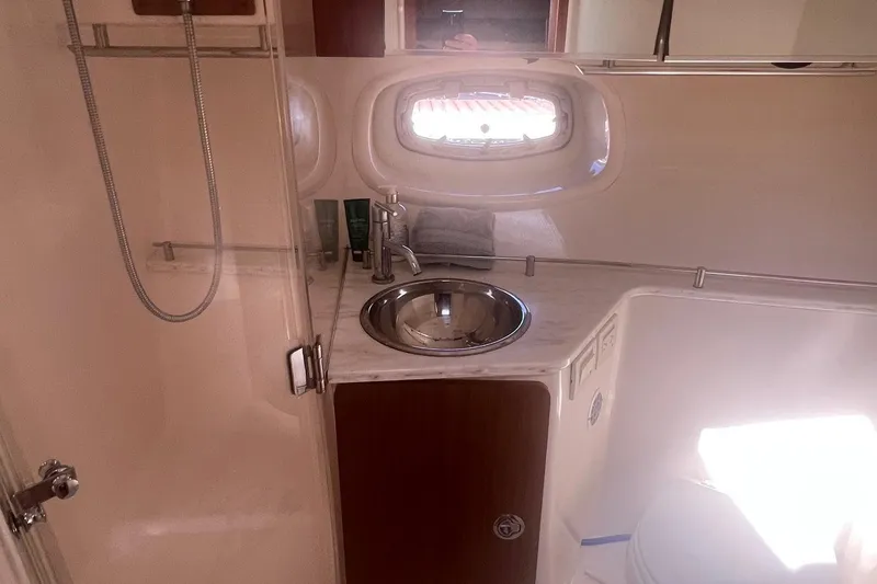 Slide: The Image of 2014 Tiara Yachts 3900 Coronet bathroom with sink, mirror, and shower. - 38