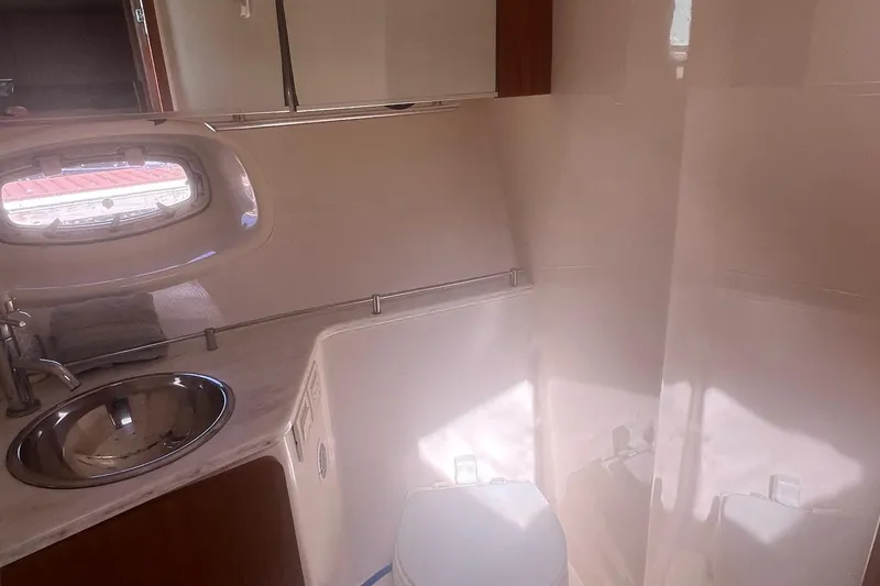 Slide: The Image of Bathroom interior of 2014 Tiara Yachts 3900 Coronet with sink and porthole window. - 39