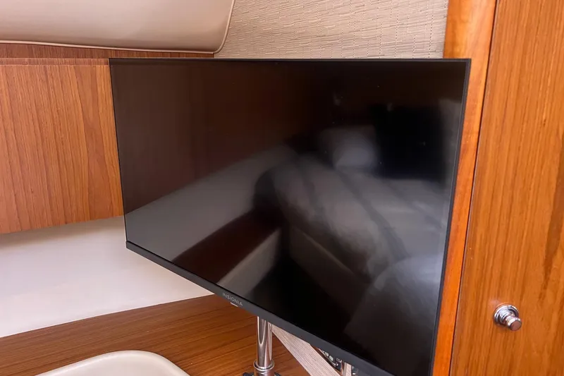 Slide: The Image of Flat-screen TV in 2014 Tiara Yachts 3900 Coronet cabin with wooden interior. - 48
