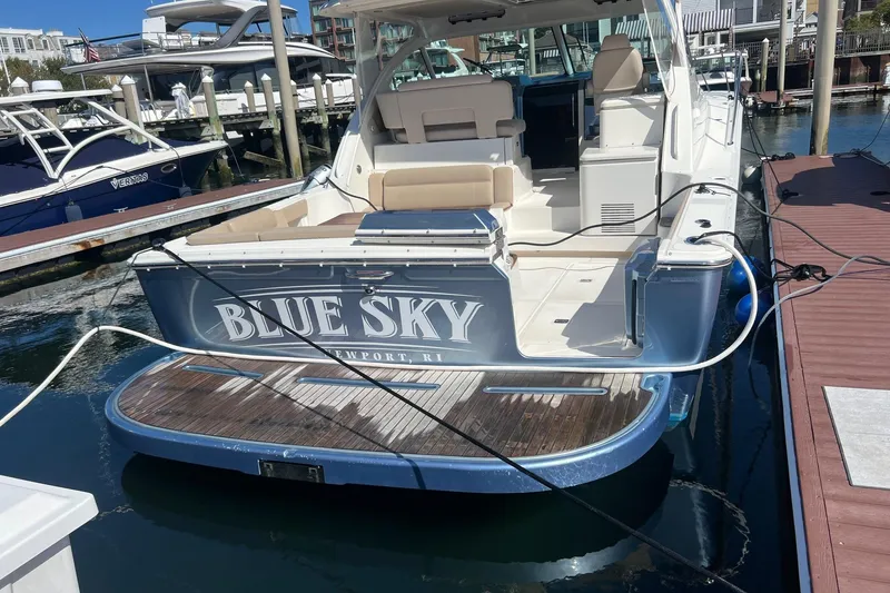 Slide: The Image of 2014 Tiara Yachts 3900 Coronet docked, rear view with "Blue Sky" name visible. - 5