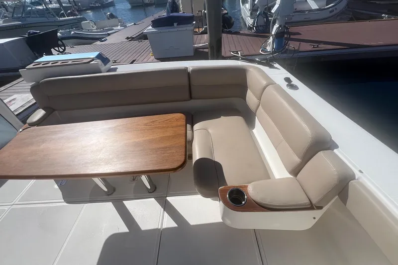Slide: The Image of Luxurious seating area on 2014 Tiara Yachts 3900 Coronet with wooden table. - 50