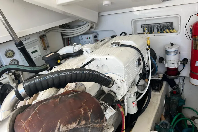 Slide: The Image of Engine room of 2014 Tiara Yachts 3900 Coronet, showcasing mechanical components and fire extinguisher. - 55
