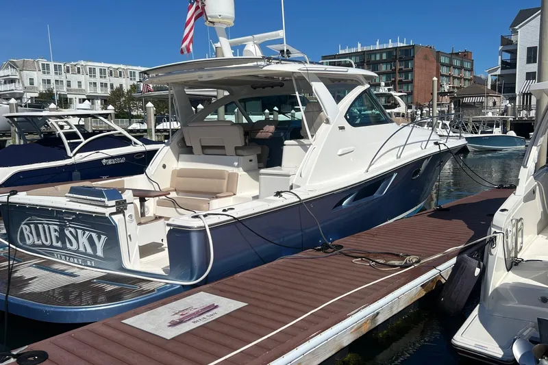 Slide: The Image of 2014 Tiara Yachts 3900 Coronet docked, featuring sleek design and spacious deck. - 7