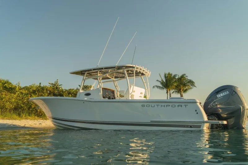 Slide: The Image of 2026 Southport 33 FE boat on calm water with palm trees in background. - 12