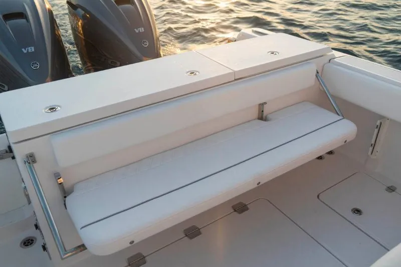 Slide: The Image of 2026 Southport 33 FE boat with foldable seating and dual engines on calm water. - 14