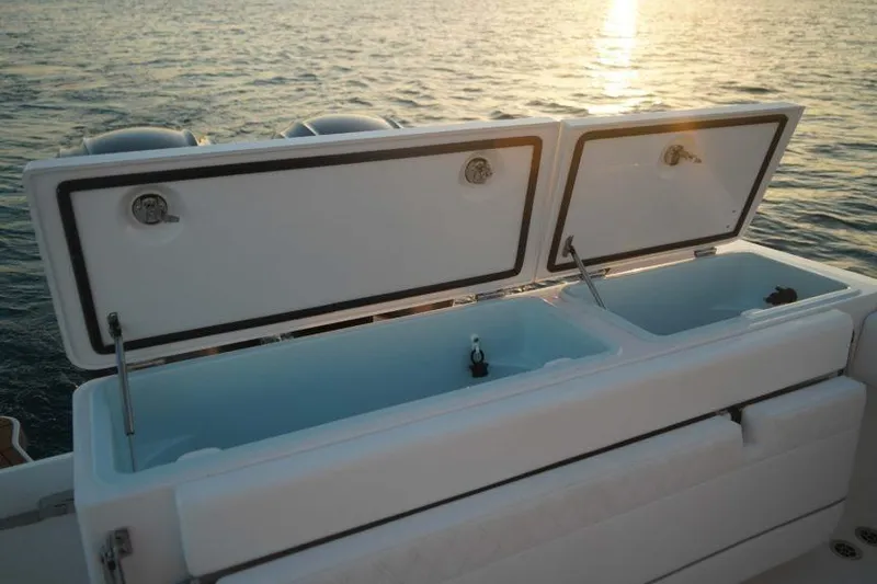 Slide: The Image of Open storage compartments on a 2026 Southport 33 FE boat at sunset. - 15