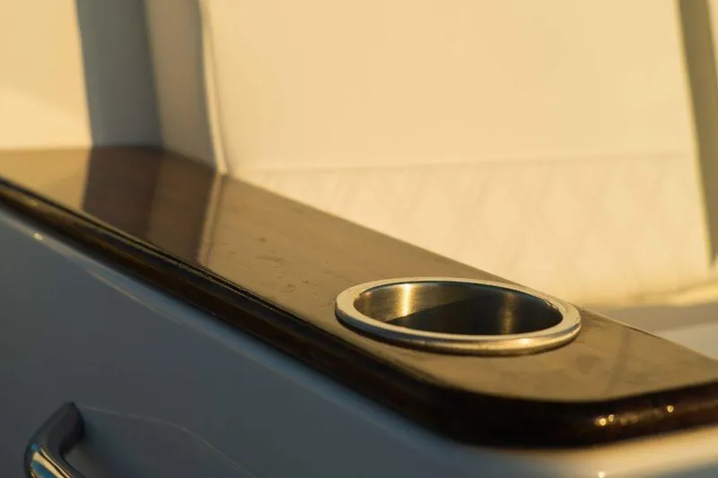 Slide: The Image of Cup holder on Southport 33 FE boat, 2026 model, with sleek wooden finish. - 5