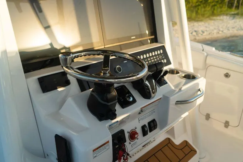 Slide: The Image of Steering console of 2026 Southport 33 FE boat with modern controls and displays. - 9