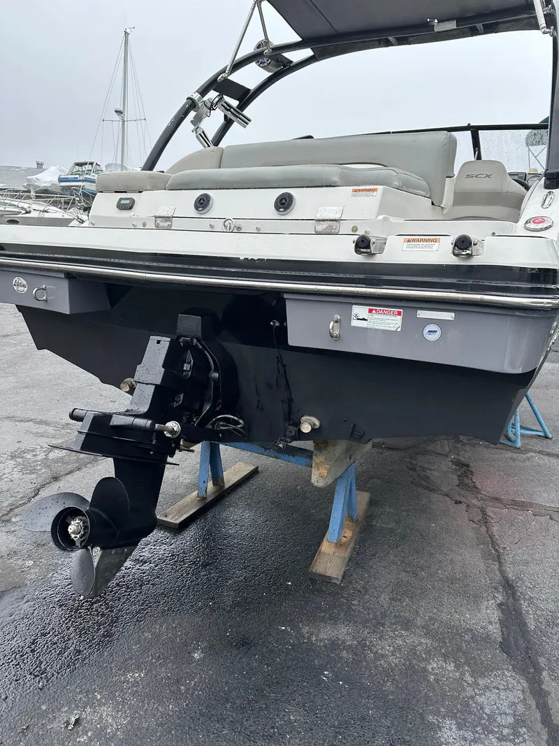 Slide: The Image of 2014 Starcraft Crossover 210 SCX IO boat on stands, rear view with propeller visible. - 7