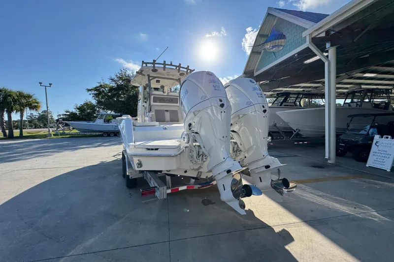 Slide: The Image of 2026 Solace 28 HCS boat with dual outboard engines in a sunny marina setting. - 16