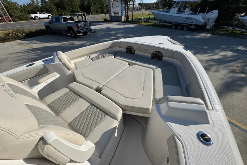 Slide: The Image of 2026 Solace 28 HCS boat with luxurious seating and modern design in a parking area. - 19