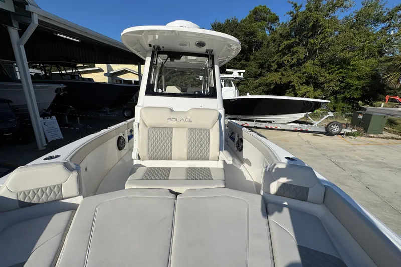 Slide: The Image of 2026 Solace 28 HCS boat with luxurious seating and modern design in a marina setting. - 24