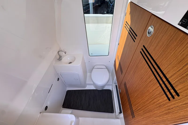 Slide: The Image of Modern bathroom interior of 2026 Solace 28 HCS boat with sink and toilet. - 28