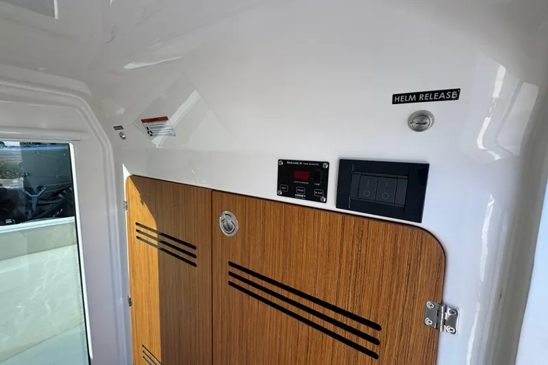 Slide: The Image of Interior of 2026 Solace 28 HCS boat with helm release and control panel. - 30