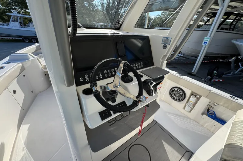 Slide: The Image of 2026 Solace 28 HCS boat cockpit with steering wheel and control panel. - 34