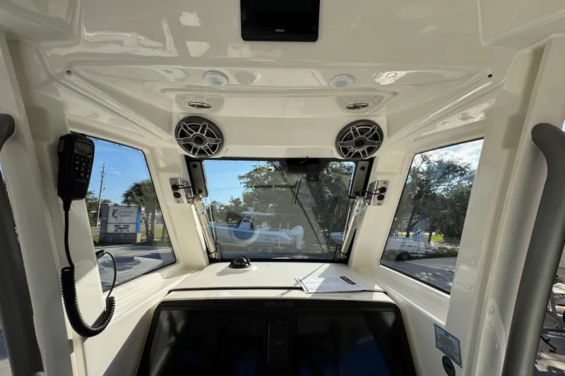 Slide: The Image of Interior view of 2026 Solace 28 HCS boat cockpit with speakers and navigation equipment. - 36