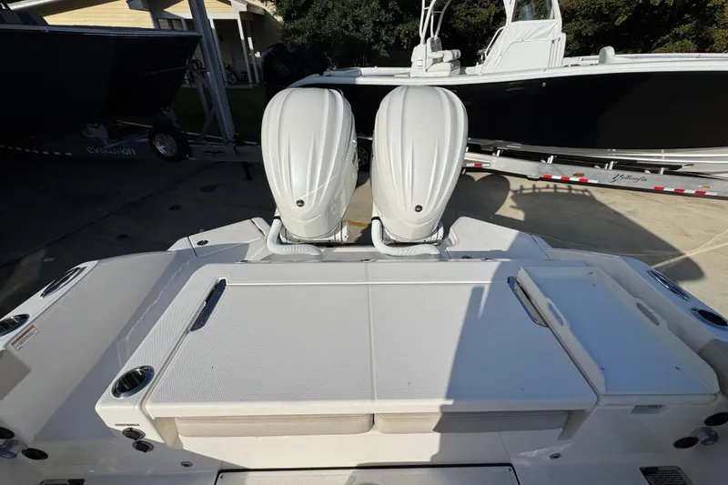 Slide: The Image of 2026 Solace 28 HCS boat with dual outboard engines, docked on a trailer. - 40