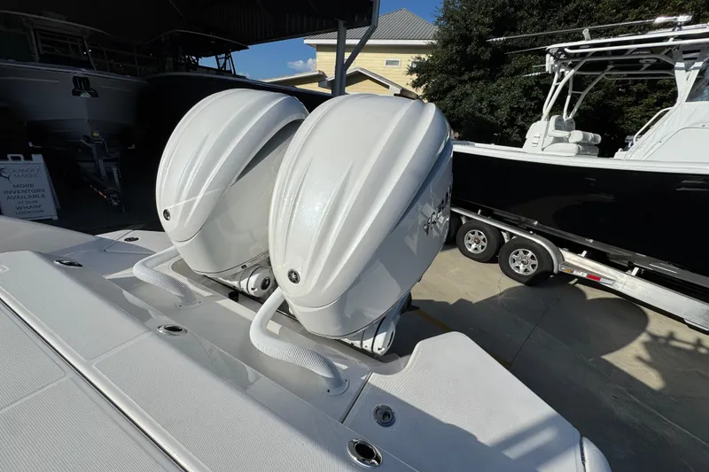 Slide: The Image of Twin outboard engines on a 2026 Solace 28 HCS boat, parked in a marina. - 42