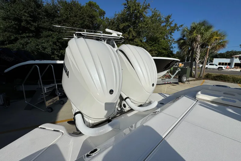 Slide: The Image of Twin Yamaha outboard engines on a 2026 Solace 28 HCS boat, parked outdoors. - 43