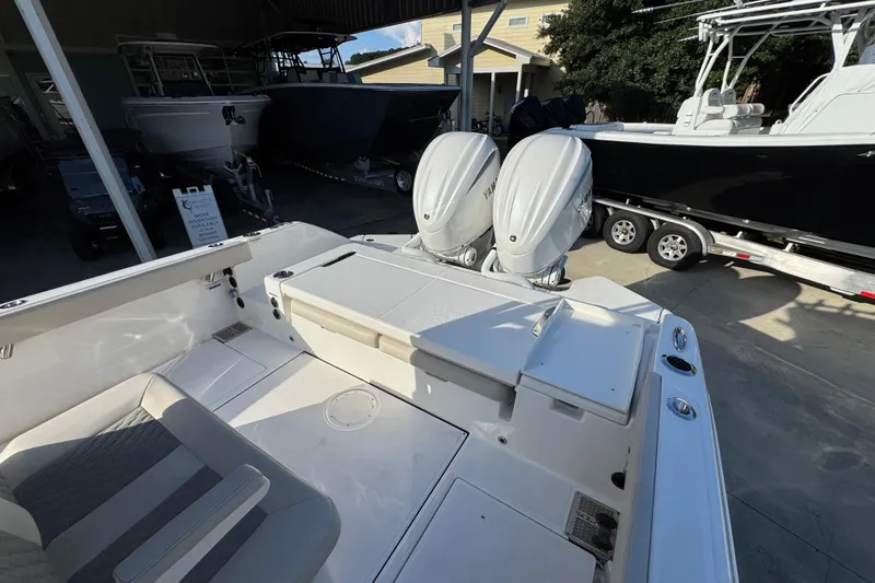 Slide: The Image of 2026 Solace 28 HCS boat with dual outboard engines in a showroom setting. - 45