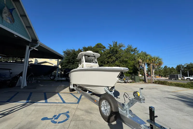 Slide: The Image of 2026 Solace 28 HCS boat on trailer in parking lot under clear blue sky. - 7