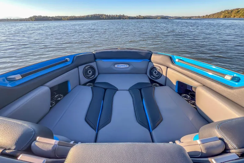 Slide: The Image of 2024 Supra SV 400 boat interior with luxurious seating on a serene lake. - 12