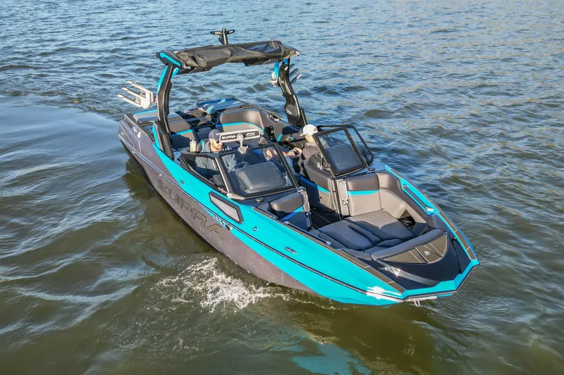 Slide: The Image of 2024 Supra SV 400 boat cruising on open water, featuring sleek design and vibrant blue accents. - 16