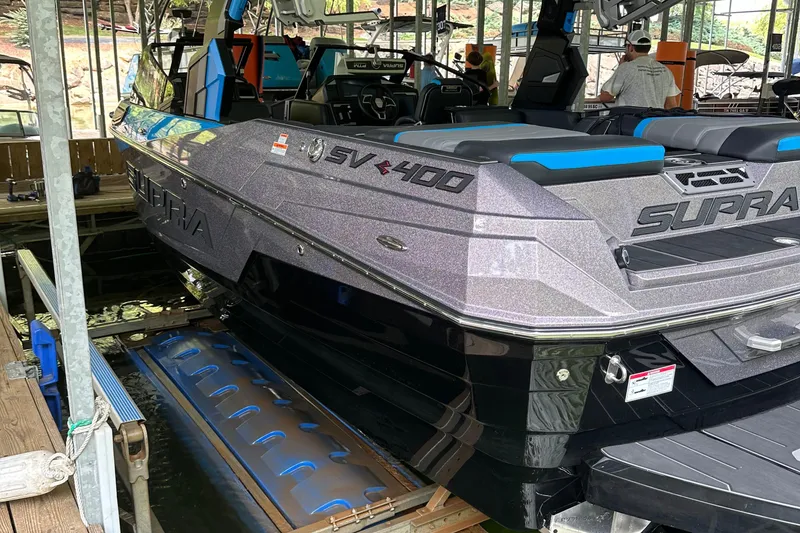 Slide: The Image of 2024 Supra SV 400 boat cruising on a lake, creating dynamic waves. - 2