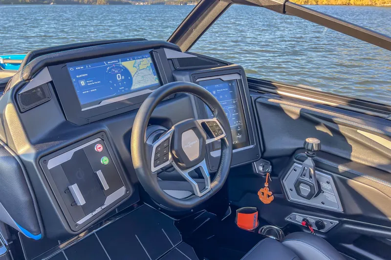 Slide: The Image of 2024 Supra SV 400 boat dashboard with advanced navigation screens and steering wheel. - 24