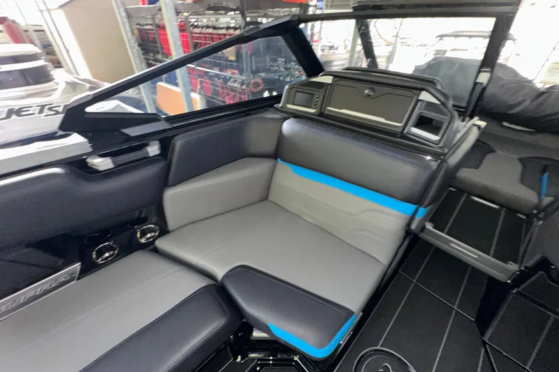 Slide: The Image of 2024 Supra SV 400 boat cruising on water, showcasing sleek design and vibrant blue accents. - 6