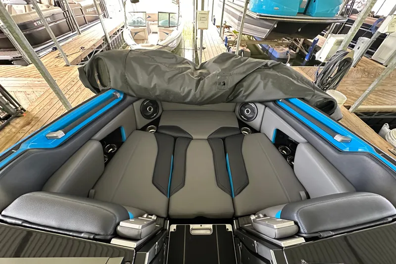 Slide: The Image of 2024 Supra SV 400 boat on a lake, featuring sleek design and vibrant blue accents. - 8