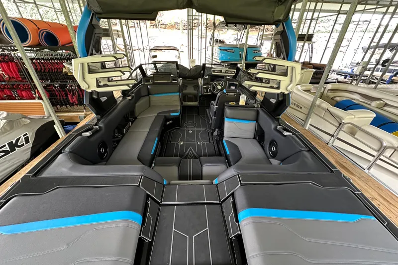 Slide: The Image of 2024 Supra SV 400 boat cruising on a serene lake under a clear blue sky. - 9