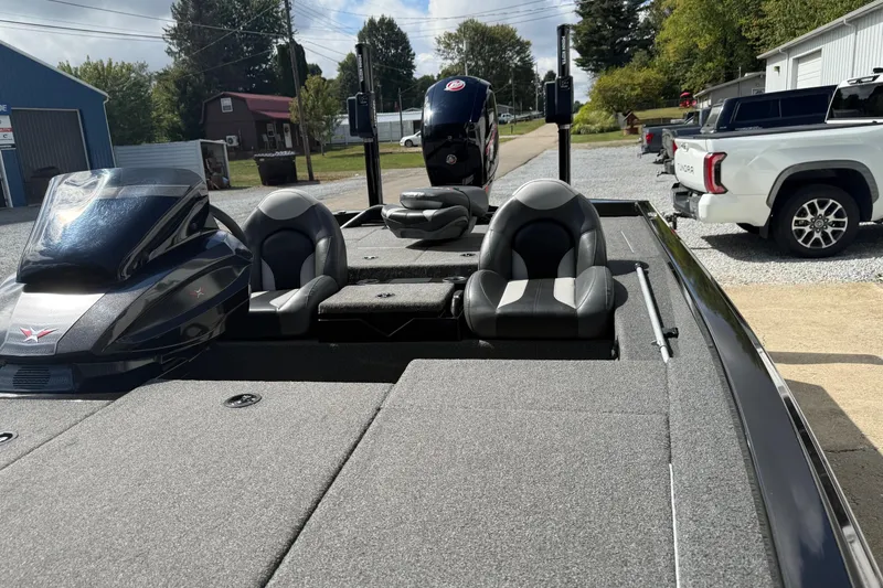 Slide: The Image of 2022 Vexus AVX1980 boat with dual seats and sleek design, parked outdoors. - 14