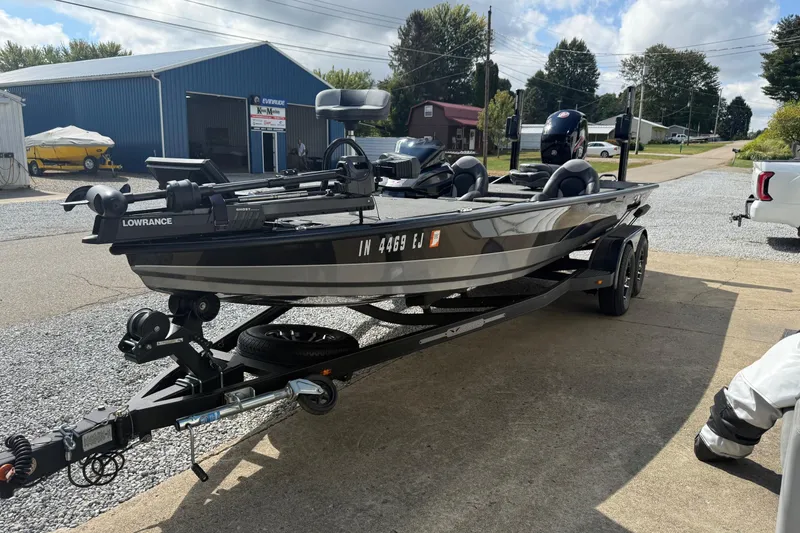 Slide: The Image of 2022 Vexus AVX1980 boat on trailer, parked outdoors near blue building. - 17