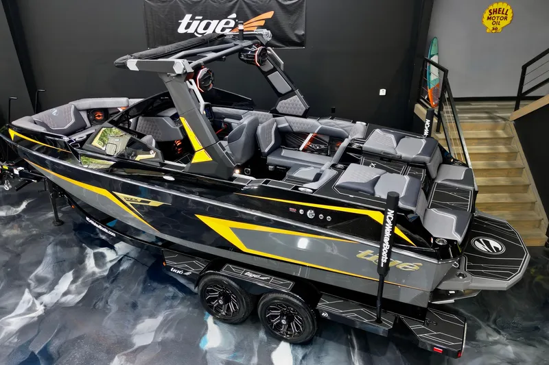 Slide: The Image of 2026 Tigé 22RZX boat with sleek design, black and yellow accents, displayed indoors. - 12