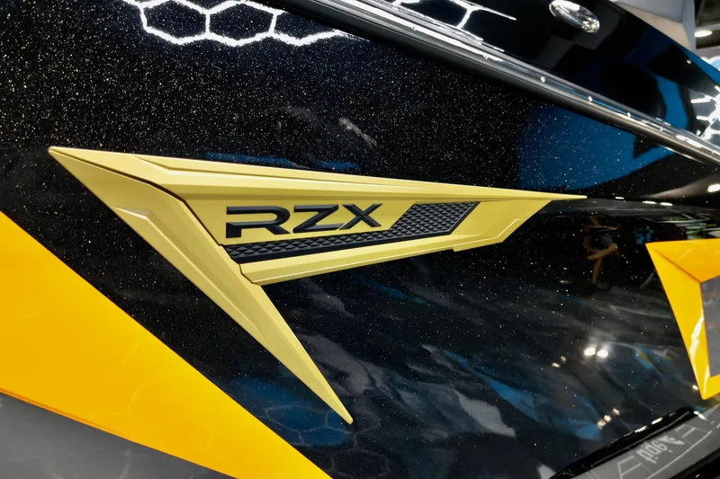 Slide: The Image of 2026 Tigé 22RZX boat emblem with sleek yellow and black design. - 23