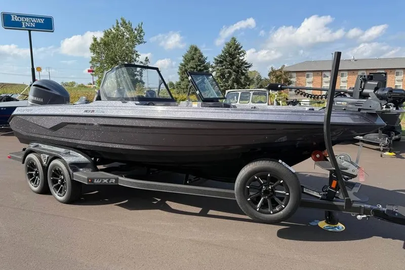 The Image of 2026 Skeeter WXR2060 boat on trailer, parked outdoors near Rodeway Inn. - 0