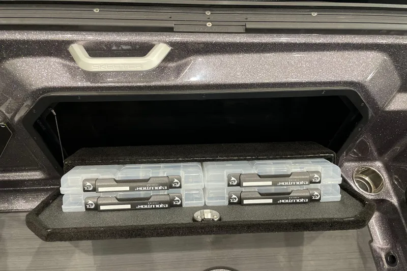 Slide: The Image of Storage compartment of 2026 Skeeter WXR2060 boat with organized tackle boxes. - 11