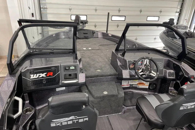 Slide: The Image of 2026 Skeeter WXR2060 boat interior with dual consoles and steering wheel in a garage setting. - 14