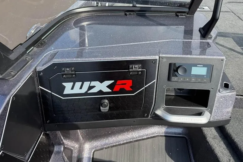 Slide: The Image of 2026 Skeeter WXR2060 boat dashboard with control panel and storage compartment. - 16